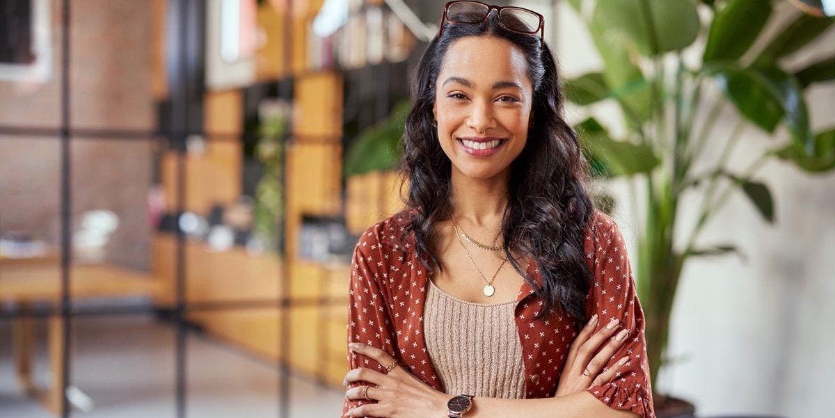 woman smiling with arms crossed in the office