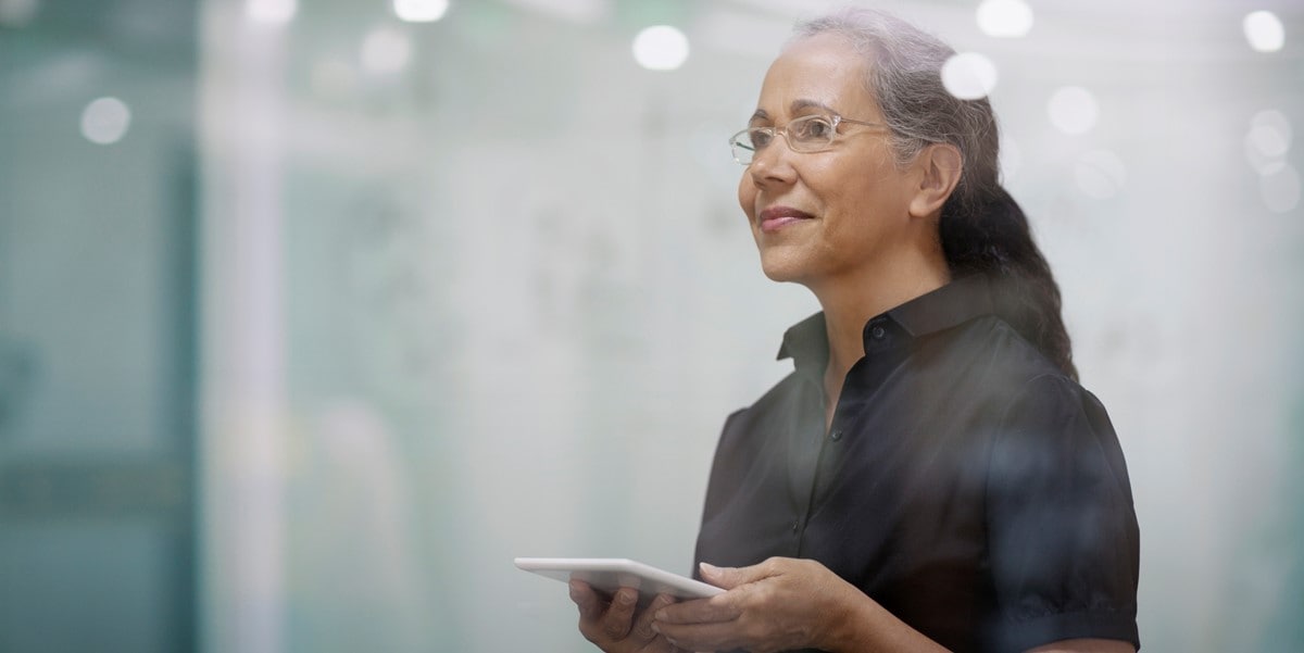 woman in the office holding a cell phone