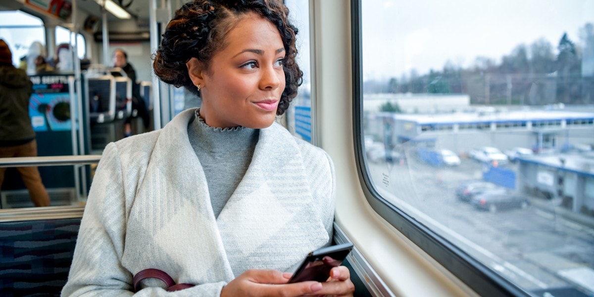 traveler on a train looking out window