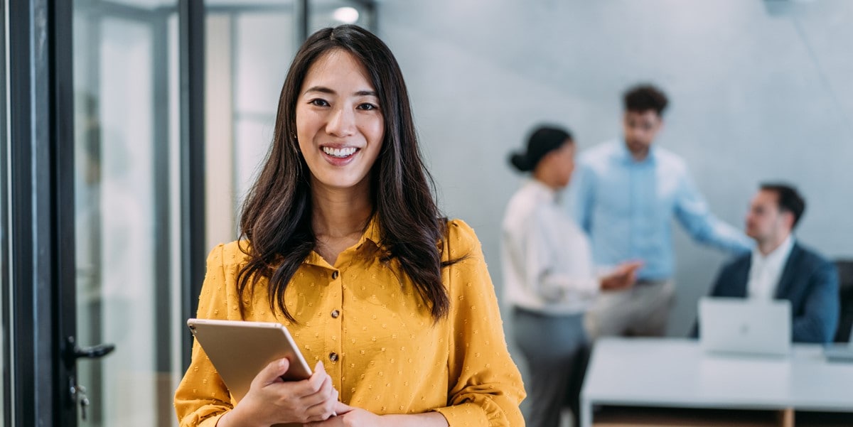 professional woman in the office holding a tablet