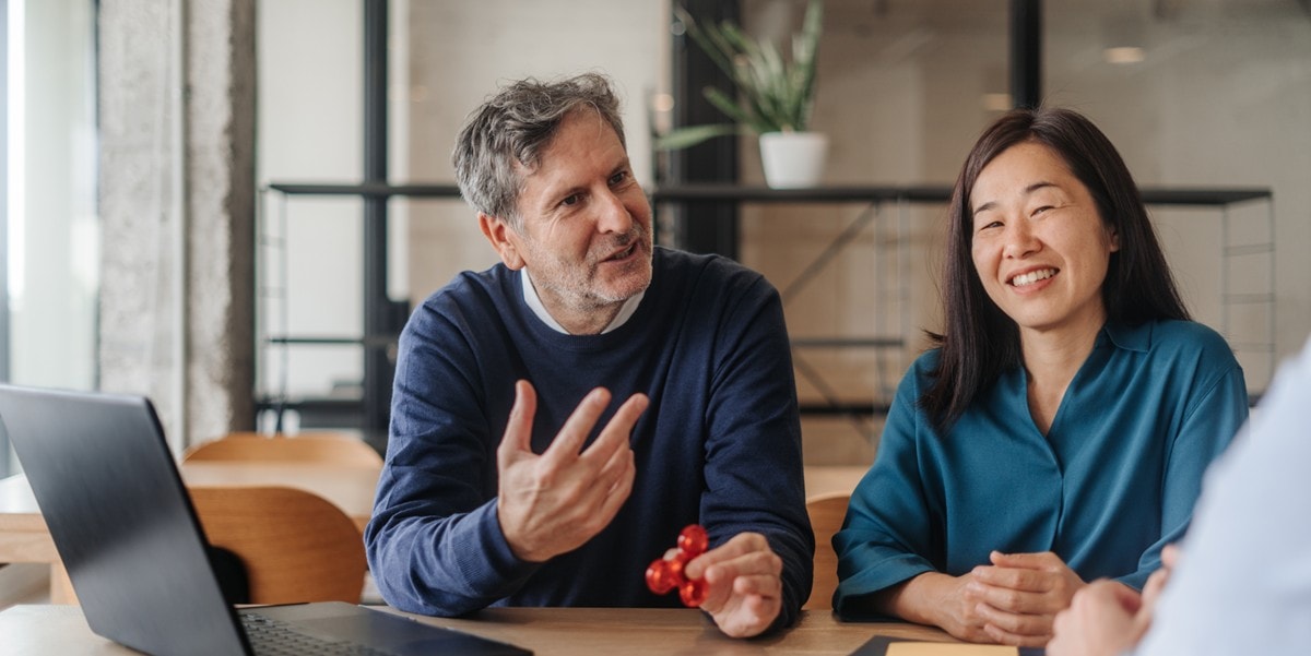 two professionals in the office sitting at a table