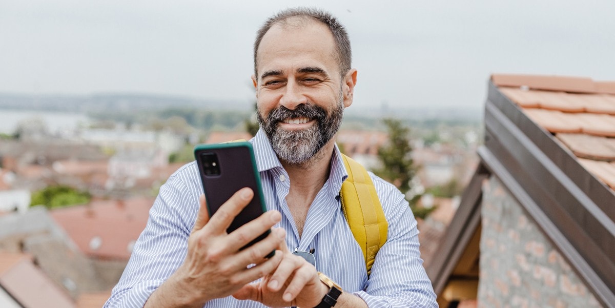 smiling traveler looking at cellphone
