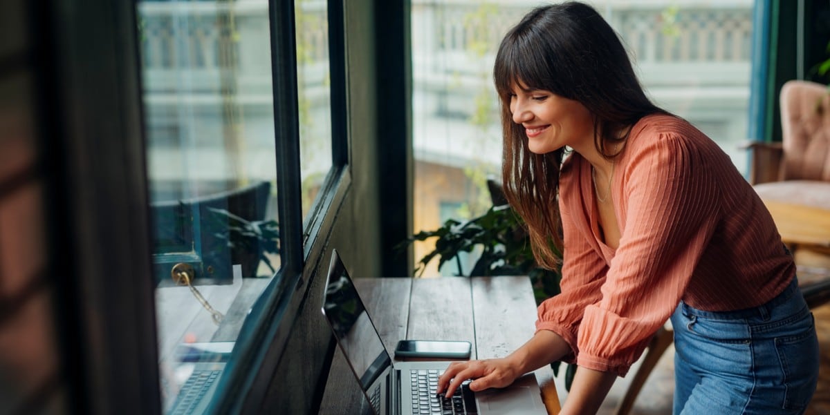 woman working at a desk using laptop