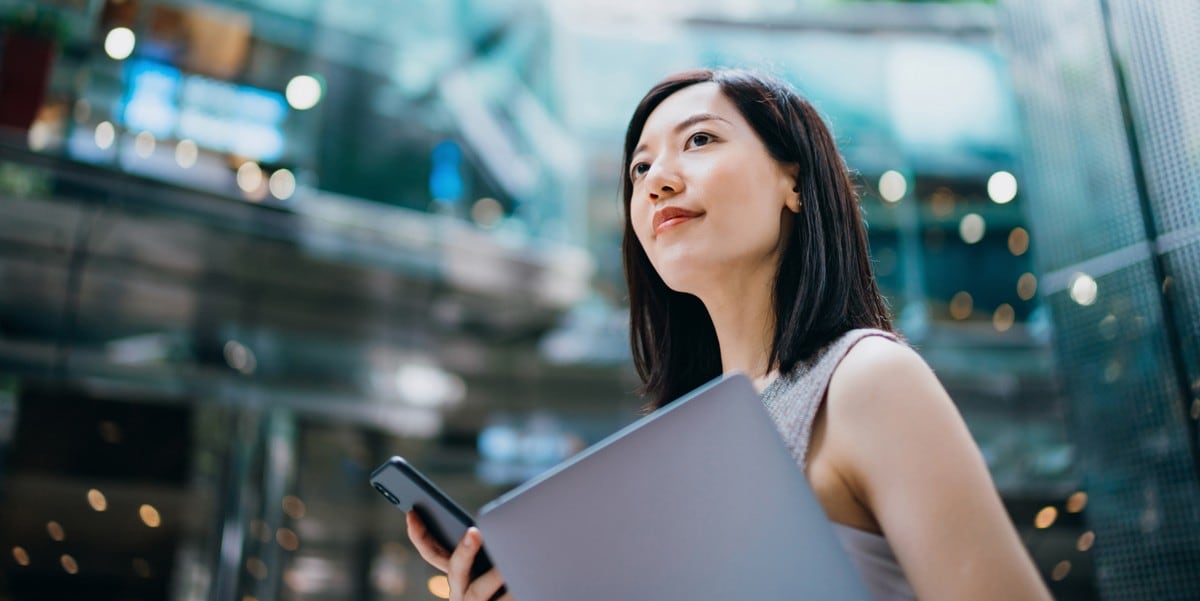 woman holding tablet and cell phone
