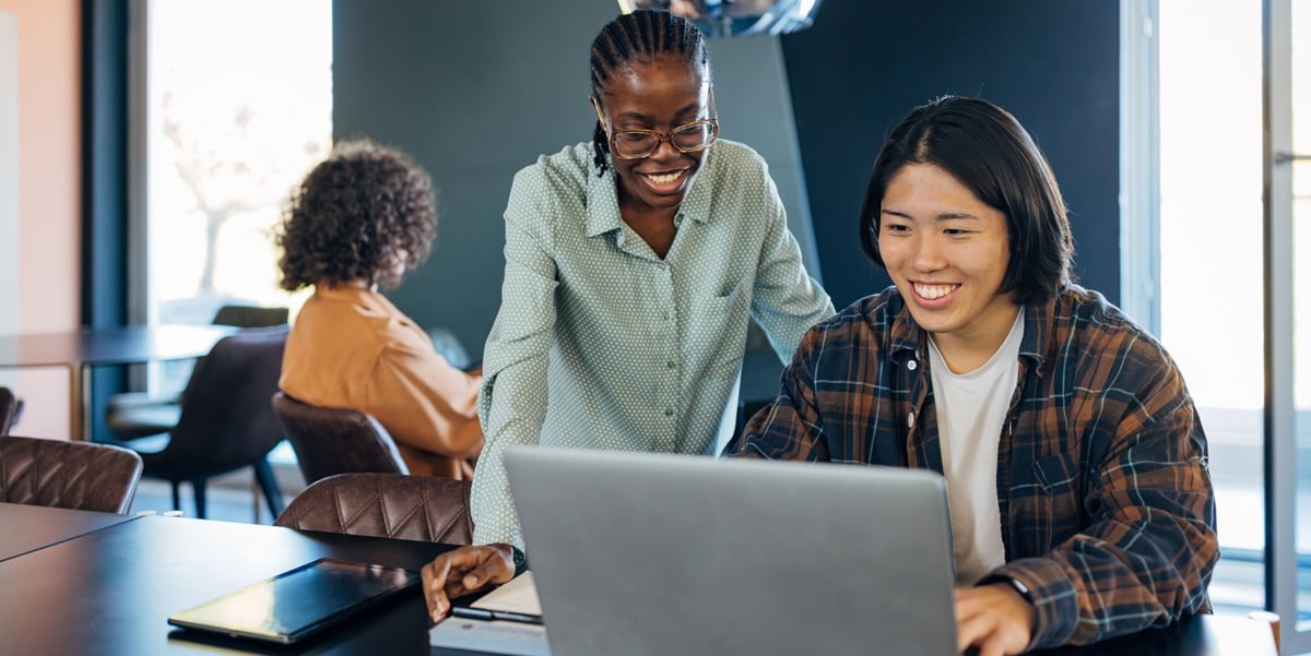 two professionals in the office looking at laptop