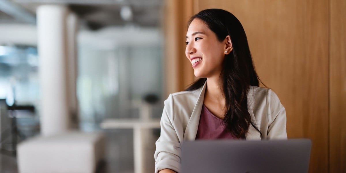 professional woman smiling, in the office