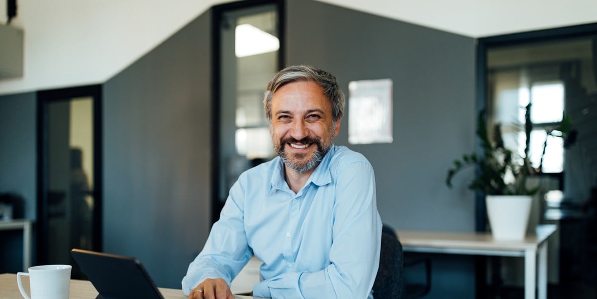 professional at desk smiling