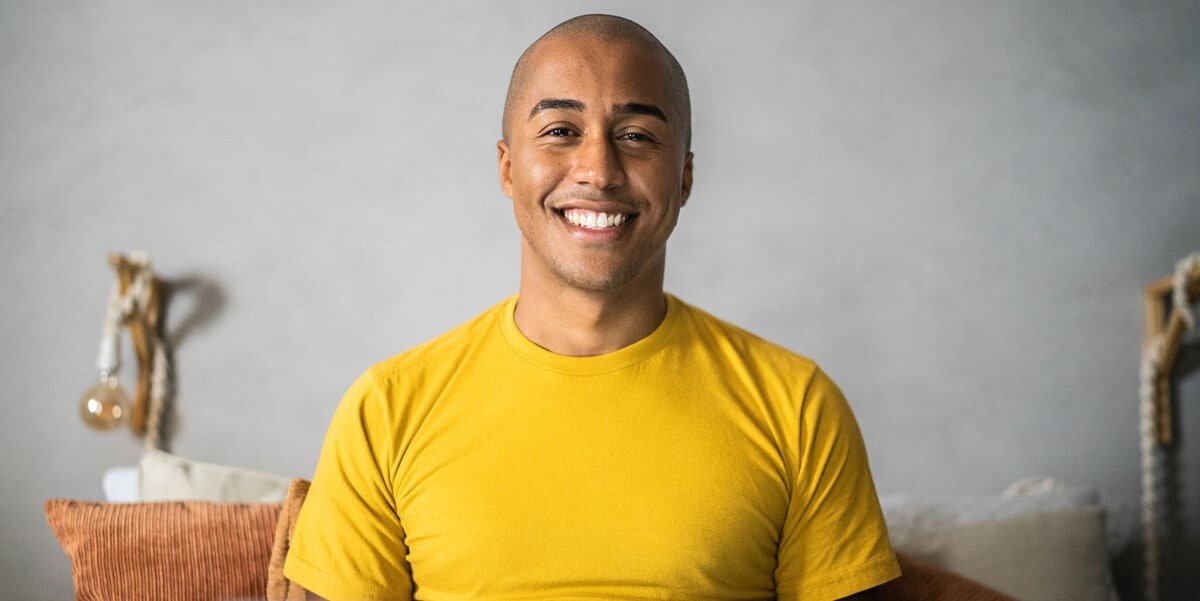 man in yellow shirt smiling
