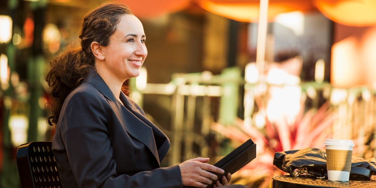 Woman sitting at a table outside