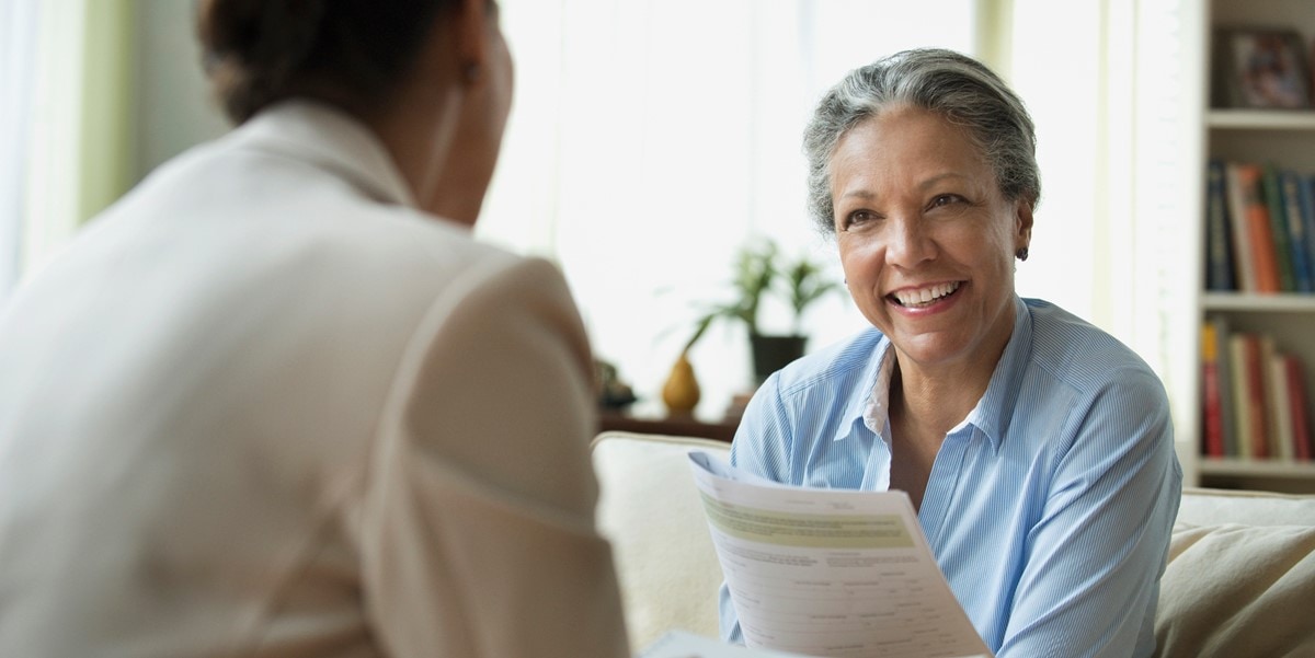 smiling woman with document in hand