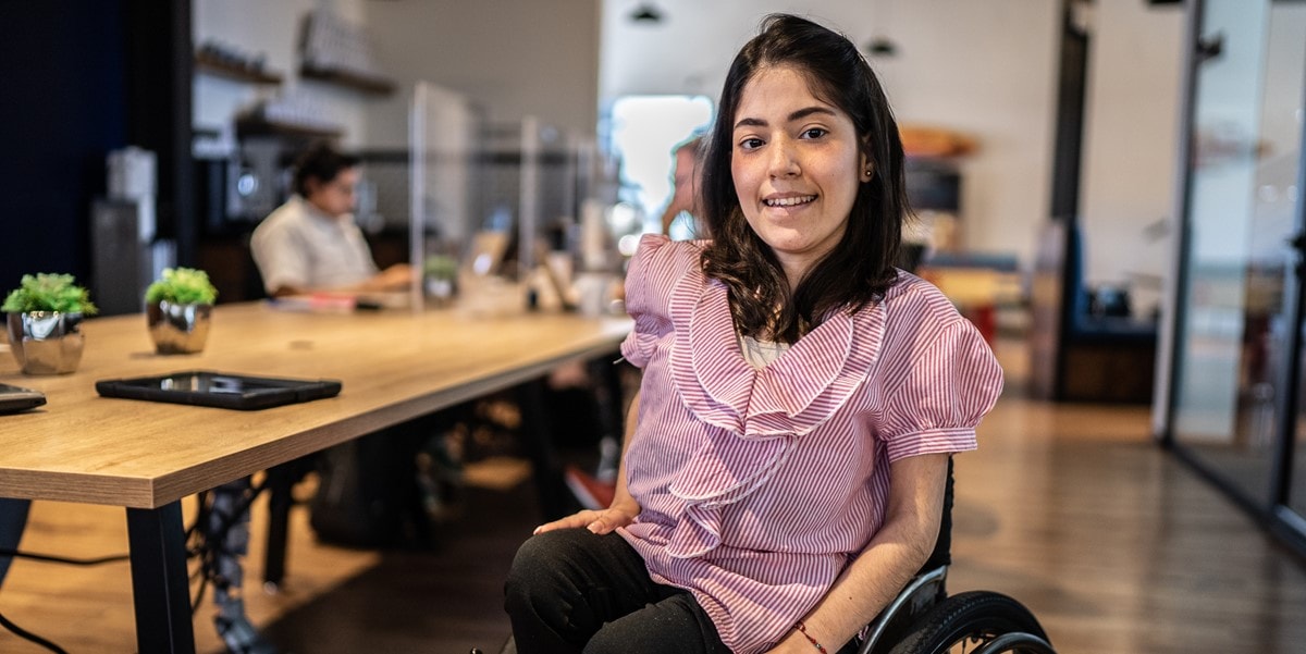 woman in wheelchair in an office 