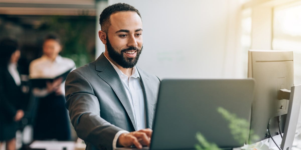 man in office using computer