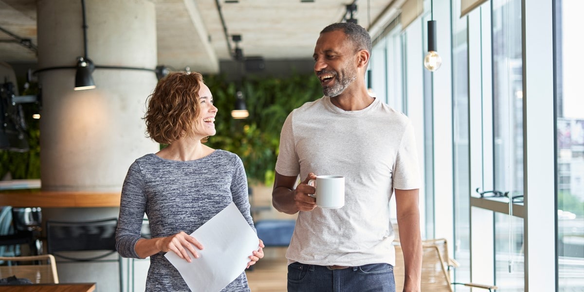 two people walking through office