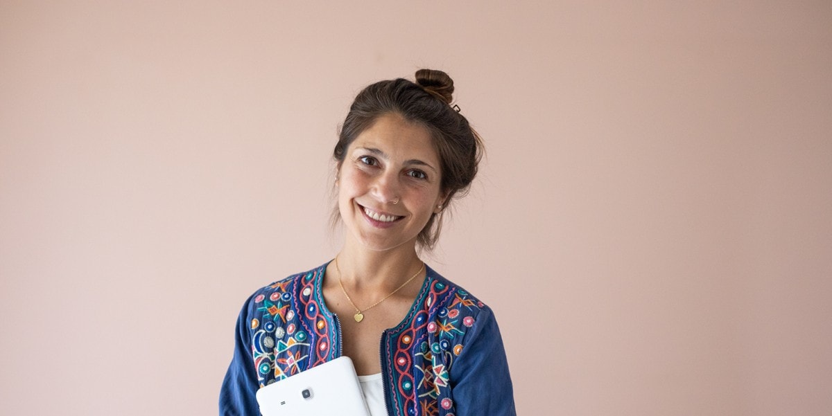 smiling woman holding a tablet