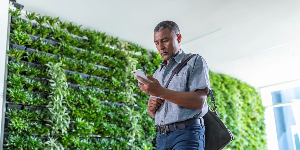 man in front of green wall