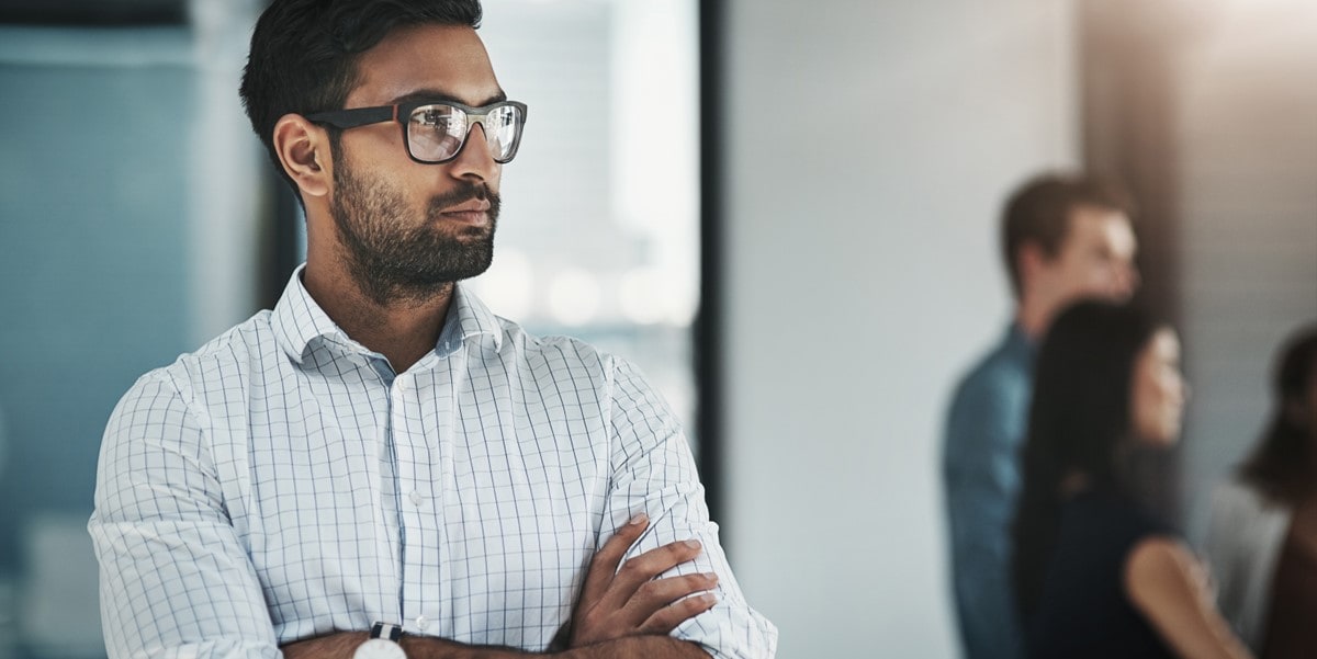 man in office with arms crossed