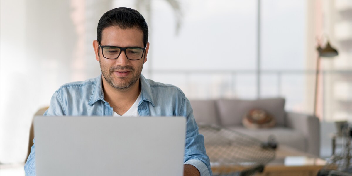 man with glasses on laptop