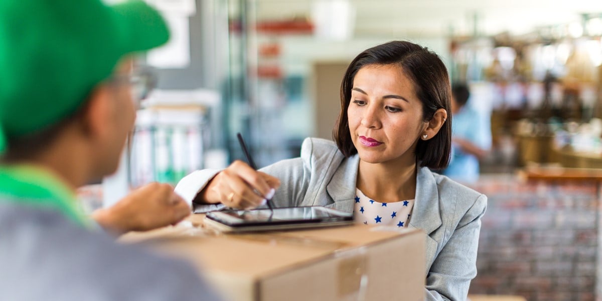 woman signing tablet for a delivery