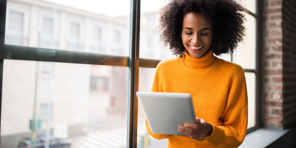 woman orange sweater looking at document